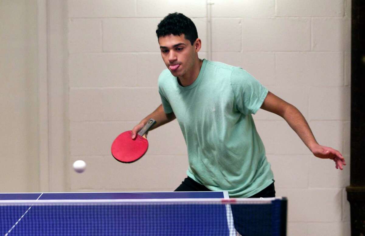 Daniel Sorial, of Stamford, returns the ball during a match against William Telemaque, of Shelton, at Crush Ping Pong on Field Point Road in Greenwich, Conn., on Saturday November 27, 2021.