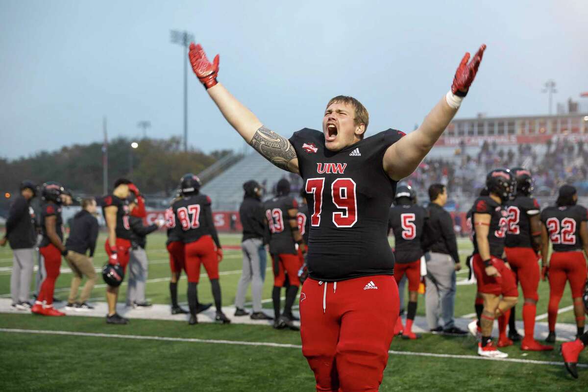 Incarnate Word Cardinals offensive lineman Joseph Kimmey (79) signals for the fans to cheer louder as his team plays defense against the Stephen F. Austin Lumberjacks in overtime of the opening round of the FCS playoffs at Benson Stadium in San Antonio, Texas, Saturday, Nov. 27, 2021. The Cardinals defeated the Lumberjacks 35-28 in overtime to advance to the second round of the FCS playoffs.