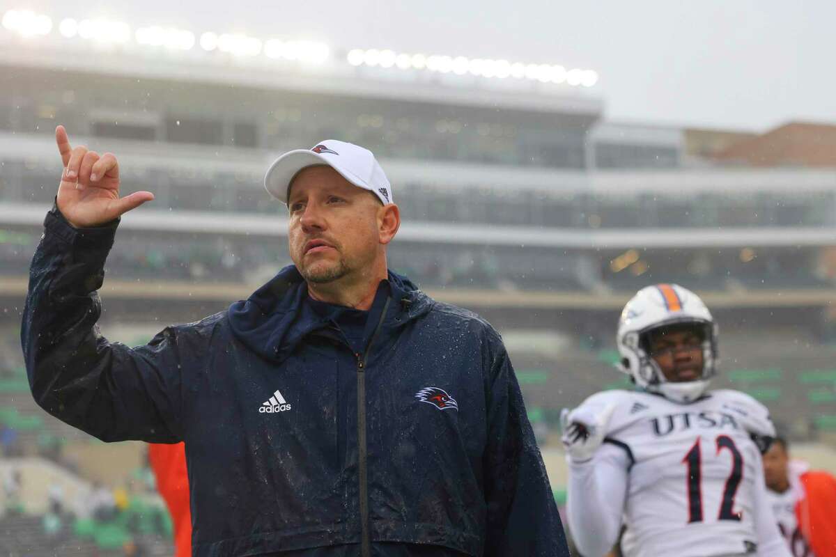 UTSA head coach Jeff Traylor signals to the crowd after losing an NCAA college football game against North Texas in Denton, Texas, Saturday, Nov. 27, 2021. (AP Photo/Andy Jacobsohn)