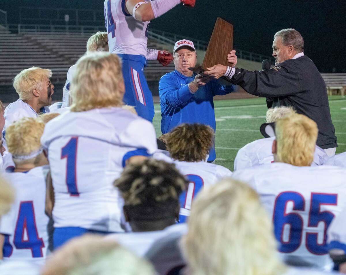 Midland Christian coach Greg McClendon presents the State Finalist trophy to his players following the 41-14 win over Central Catholic 11/27/2021 during the TAPPS Division 1 state semifinal at Gordon Wood Stadium in Brownwood, Tx. Tim Fischer/Reporter-Telegram