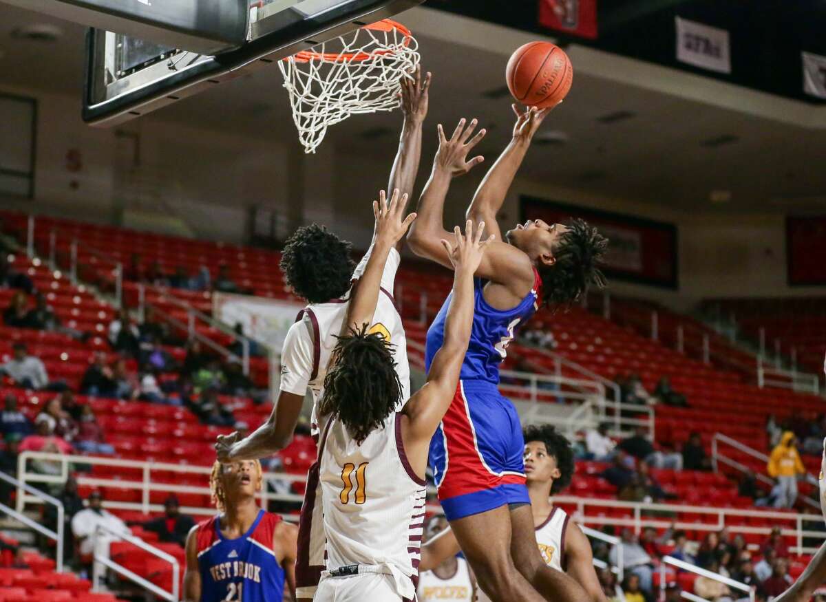 West Brook's Christian Dew (34) makes a basket Saturday afternoon at the Montagne Center in Beaumont, TX. Photo taken November 27, 2021 by Jarrod Brown