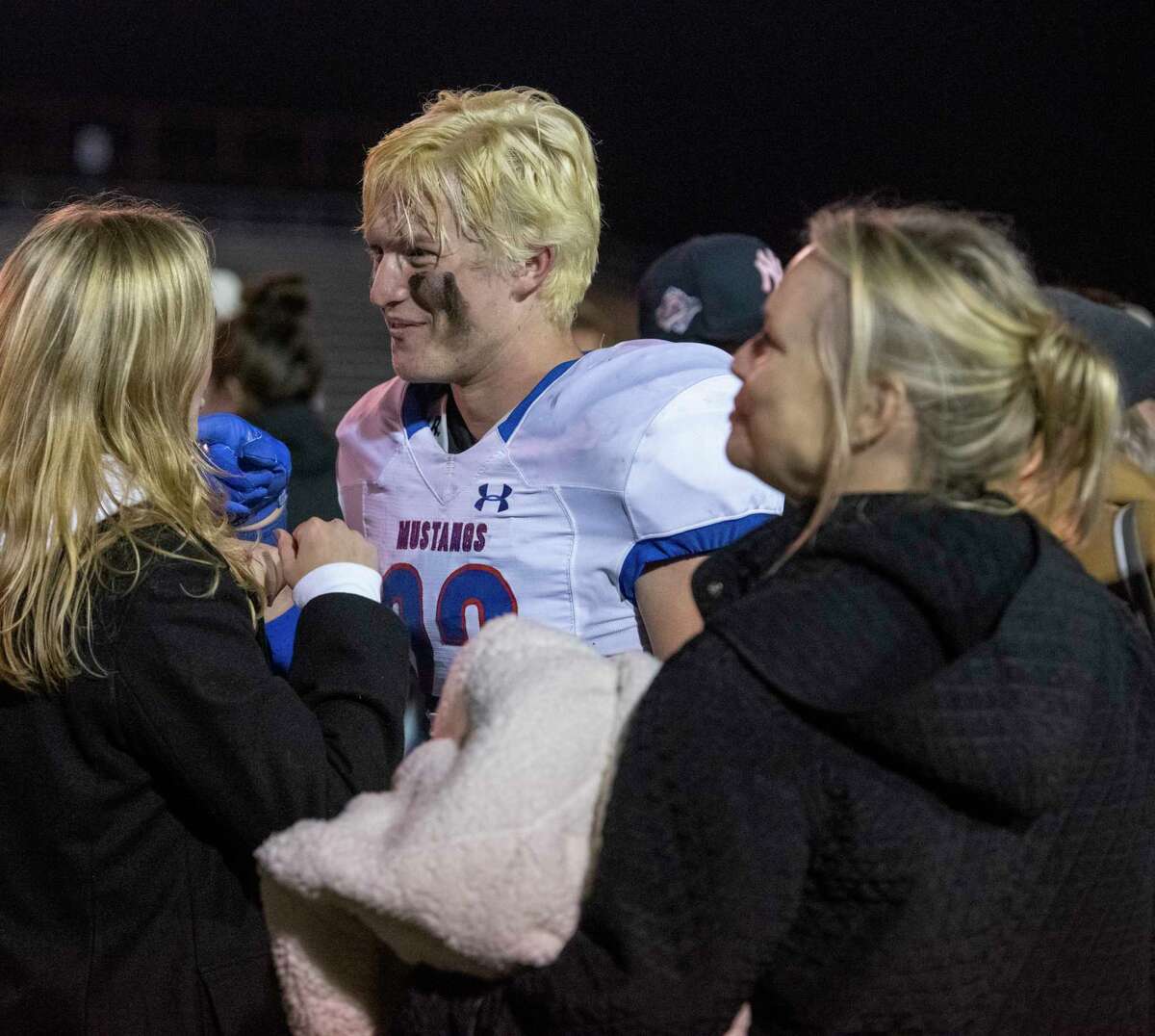 Midland Christian players gets hugs from family and friends following the 41-14 win over Central Catholic 11/27/2021 during the TAPPS Division 1 state semifinal at Gordon Wood Stadium in Brownwood, Tx. Tim Fischer/Reporter-Telegram