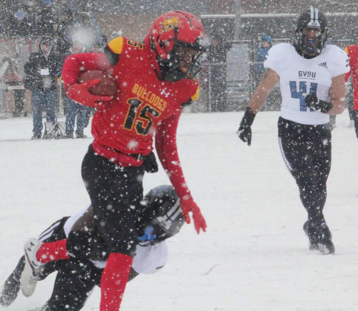 Ferris State's Xavier Wade (15) tries to keep running the ball against the Grand Valley defense on Saturday,