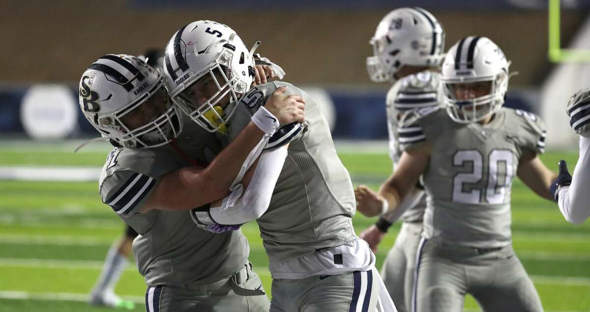 Second Baptist Karsten Chambers (5) celebrates with Everett Skillern (1) after his interception during the second half of the TAPPS Division II state semifinal game between Fort Bend Christian and Second Baptist high schools at Rice Stadium, Saturday, Nov. 27, 2021 in Houston.