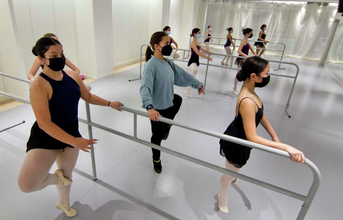 Ballet School of Stamford instructor Tara Jarboe, center, works with students at A Dance Space, the new dance studio on the fifth floor of Stamford Town Center, in Stamford, Conn., on Wednesday, Nov. 3, 2021.