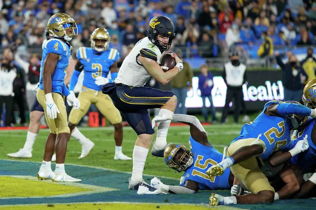 California quarterback Chase Garbers, center, scores a touchdown during the first half of the team's NCAA college football game against UCLA on Saturday, Nov. 27, 2021, in Pasadena, Calif. (AP Photo/Jae C. Hong)