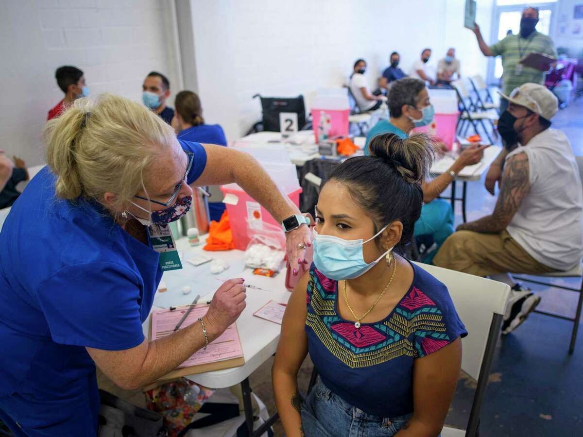 Raquel Gonzales, 27, receives a coronavirus vaccine during a free vaccination clinic in San Antonio. Some 2.6 million Texans have gotten their booster, according to state health numbers.