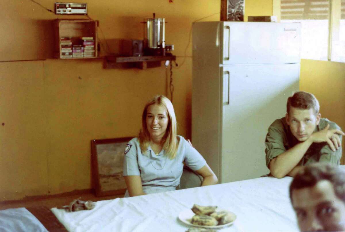 A "Donut Dolly" now identified as Karen Jankowski is shown visiting U.S. Army troops at the regional forces camp in the village of Dong Xoai, Vietnam, in 1971. For decades, Army veteran Jim Roberts searched for the two women who visited his team that day so he could thank them. Sitting on the right (full face) is Capt. Jim Rice, leader of the Mobile Advisory Team. Partially seen is the unidentified escort officer who was accompanying the Dollies on the tour.