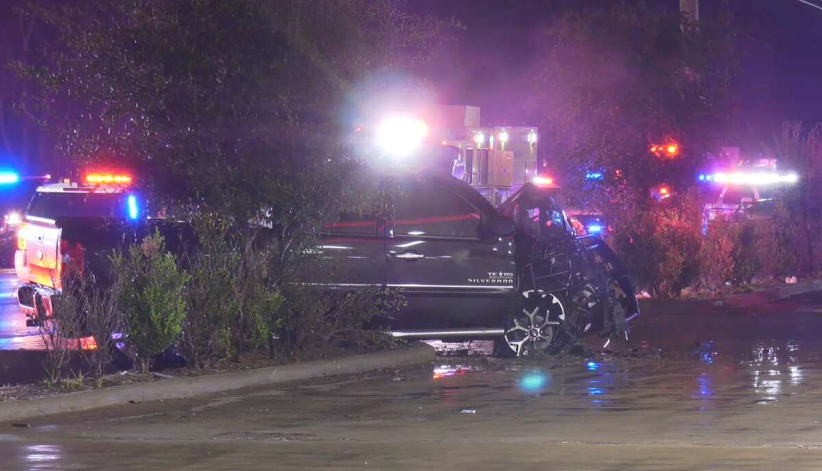 A black pickup truck lies at the scene of a fatal crash Nov. 27, 2021, in north Houston. 