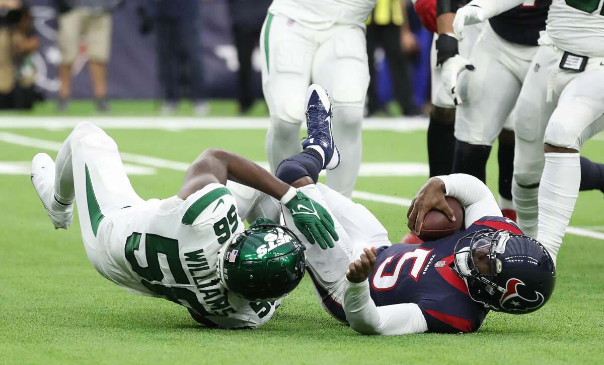 Houston Texans quarterback Tyrod Taylor (5) is sacked by New York Jets linebacker Quincy Williams (56) during the first half of an NFL football game at NRG Stadium, Sunday, Nov. 28, 2021 in Houston.
