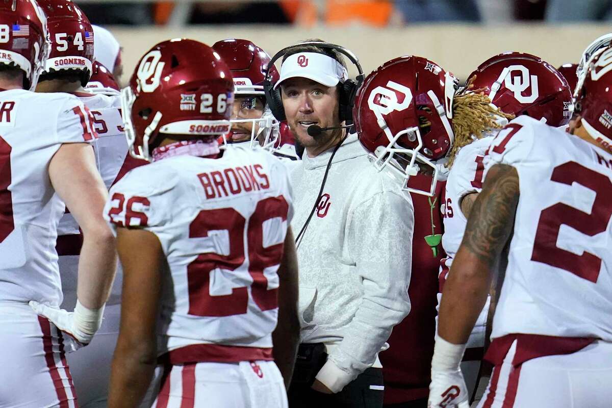 Oklahoma head coach Lincoln Riley talks with his players during the second half of an NCAA college football game against Oklahoma State, Saturday, Nov. 27, 2021, in Stillwater, Okla. (AP Photo/Sue Ogrocki)