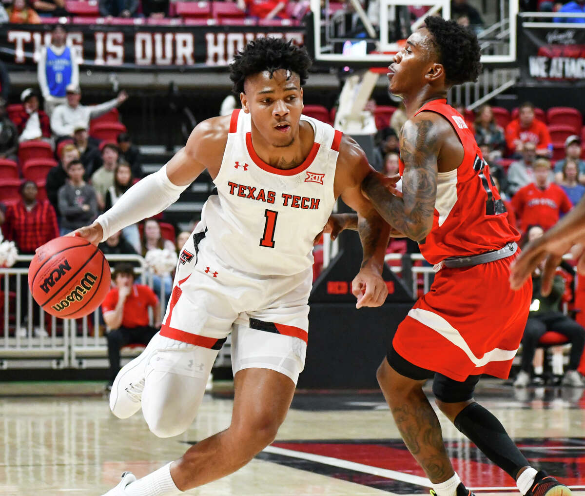 Texas Tech's Terrence Shannon, Jr. tries to get by Lamar defender Davion Buster during their men's college basketball game on Saturday in United Supermarkets Arena at Lubbock. 