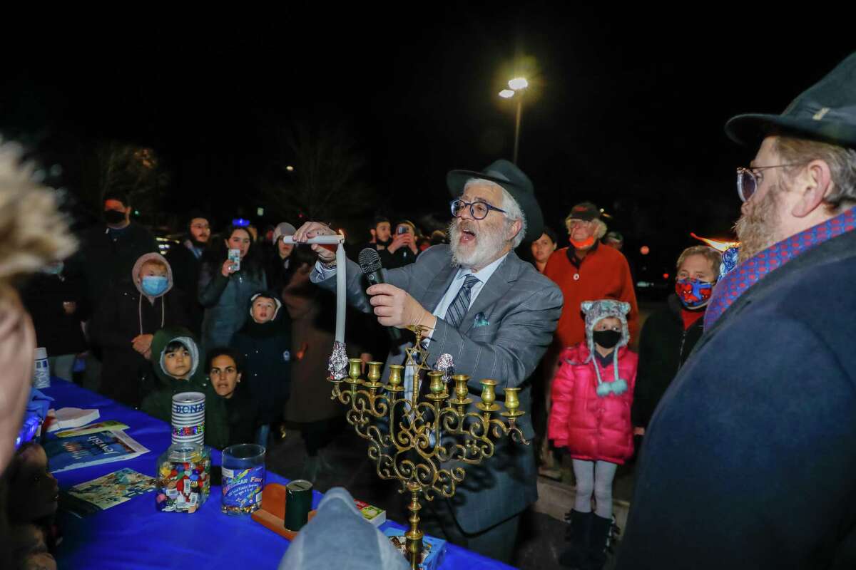 Rabbi Yehoshua Hecht, of Beth Israel of Westport/Norwalk, leads the menorah lighting Sunday evening outside Stew Leonard’s in Norwalk.
