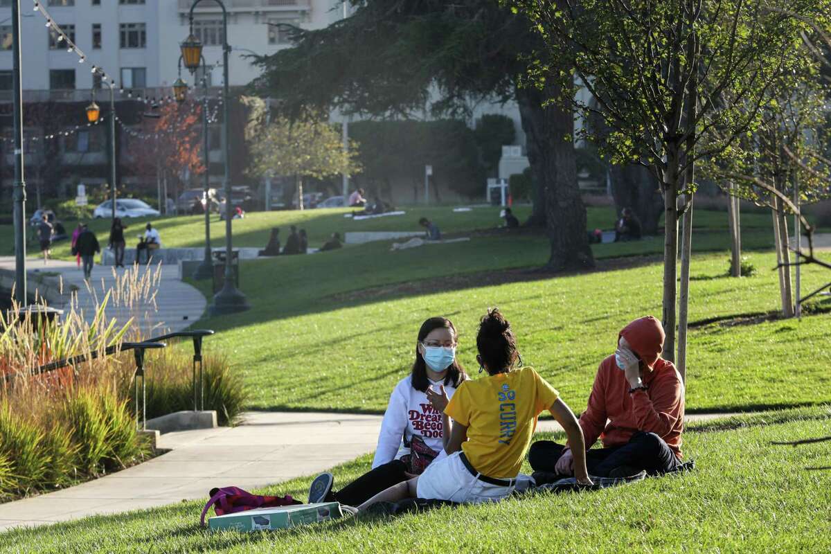 Sunny skies brought small crowds of people, masked and maskless, at Lake Merritt in Oakland. An unusually warm weekend helped break one Bay Area high-temperature record and match two others.