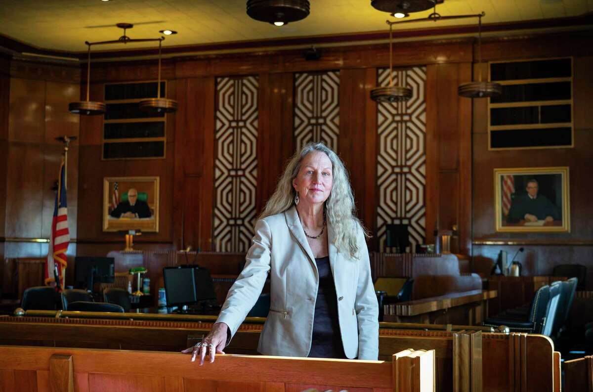 Lise Olsen, former investigative reporter for the Houston Chronicle, who recently published a book titled “Code of Silence,” is photographed, Tuesday, Nov. 16, 2021, at United States Post Office and Courthouse building in Galveston. This was the courtroom of U.S. District Judge Samuel Bristow Kent, who was impeached for sexually assaulting two of his court staffers. The book looks at the courts from the vantage point of the MeToo era.