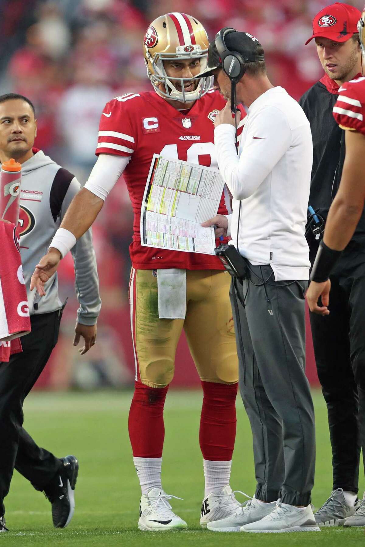 San Francisco 49ers' Jimmy Garoppolo confers with head coach Kyle Shanahan in 4th quarter of 34-26 win over Minnesota Vikings during NFL game at Levi's Stadium in Santa Clara, Calif., on Sunday, November 28, 2021.