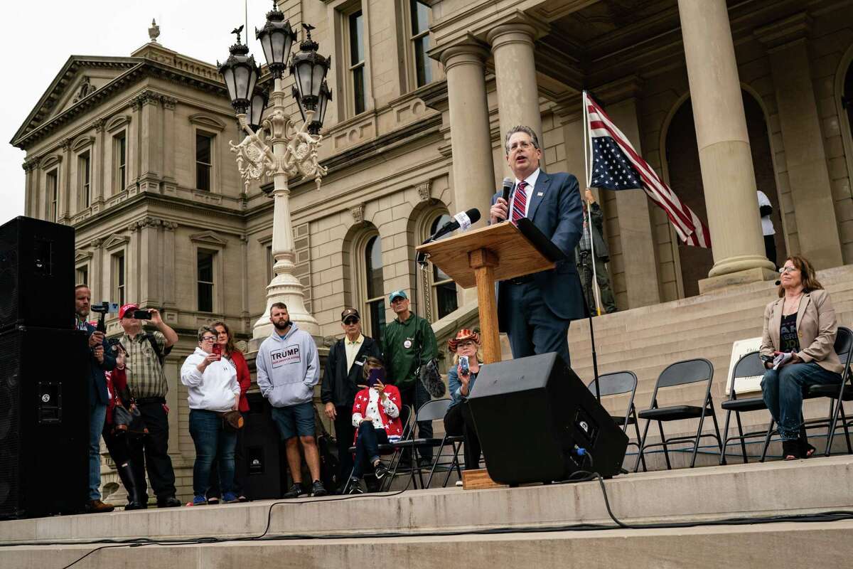 Matthew DePerno, who is seeking the GOP nomination for Michigan attorney general, addresses Trump supporters in Lansing on Oct. 12.