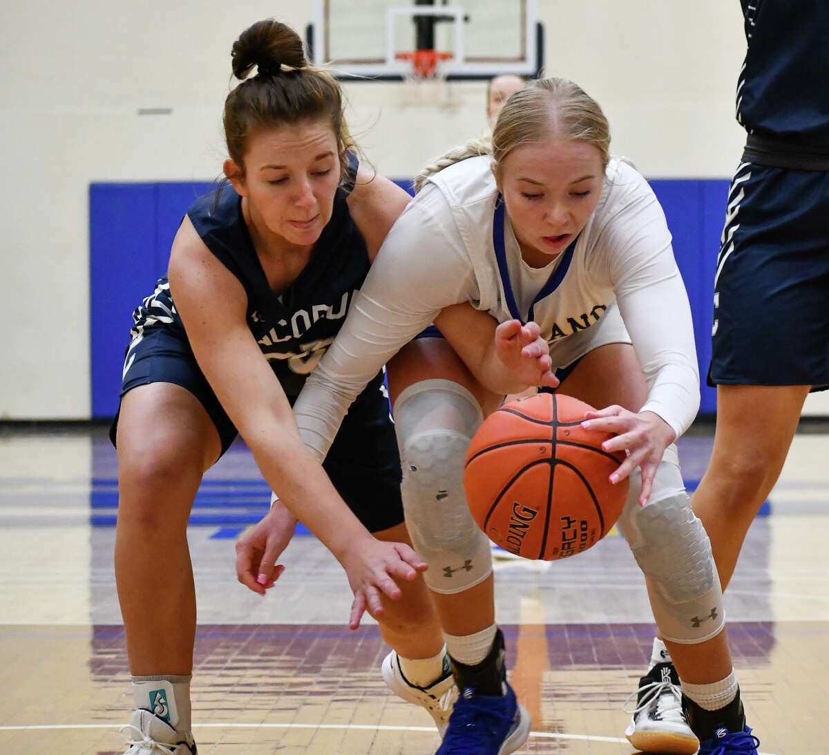 Wayland Baptist's Jenna Cooper fights for a loose ball with Concordia's Rylee Pauli during their women's basketball game on Saturday afternoon in the Hutcherson Center. 