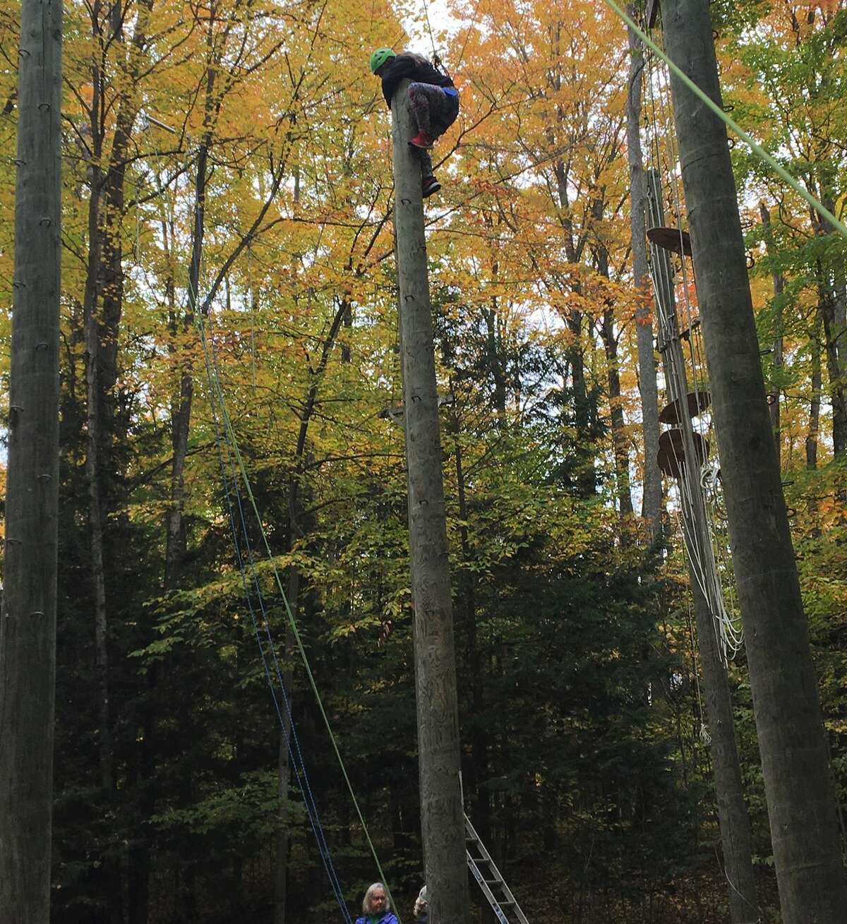 CASMAN Academy student Heaven Blair scales a wooden pole at Camp Daggett in Petoskey as part of the Jobs for Michigan's Graduates Leadership Day on Oct. 27.