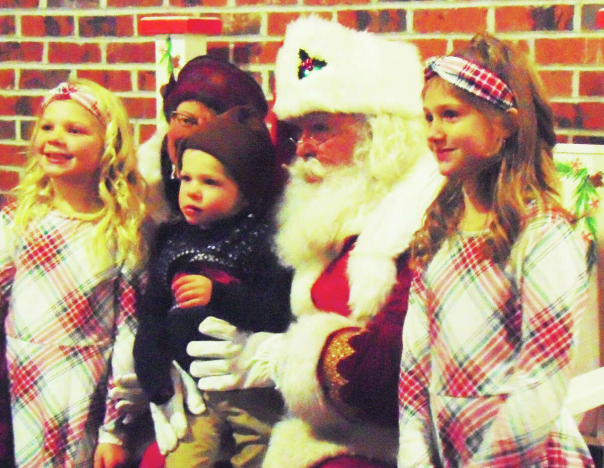 Santa was in the full holiday spirit Friday night and shared it with all the local children who attended the Evergreen Festival in downtown Reed City.
