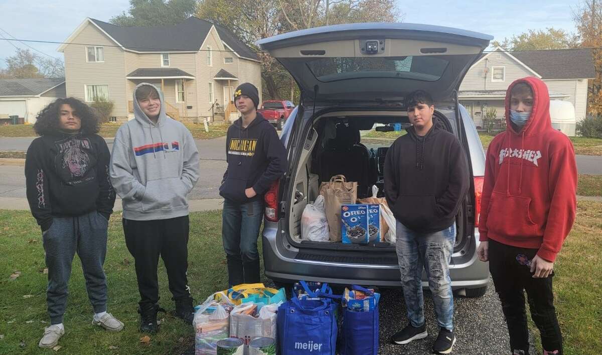 CASMAN Academy students Gabe Martinez, Riley Ward, Noah Turner, Ezperanza Leon and Drake Timson unload a donation to the school's food pantry made by the St. Joseph Ladies Guild of Onekama.
