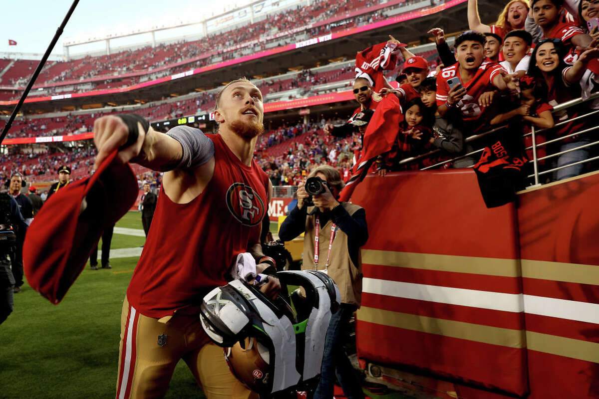 George Kittle looks to toss his hat to a fan after the game against the Minnesota Vikings at Levi's Stadium.
