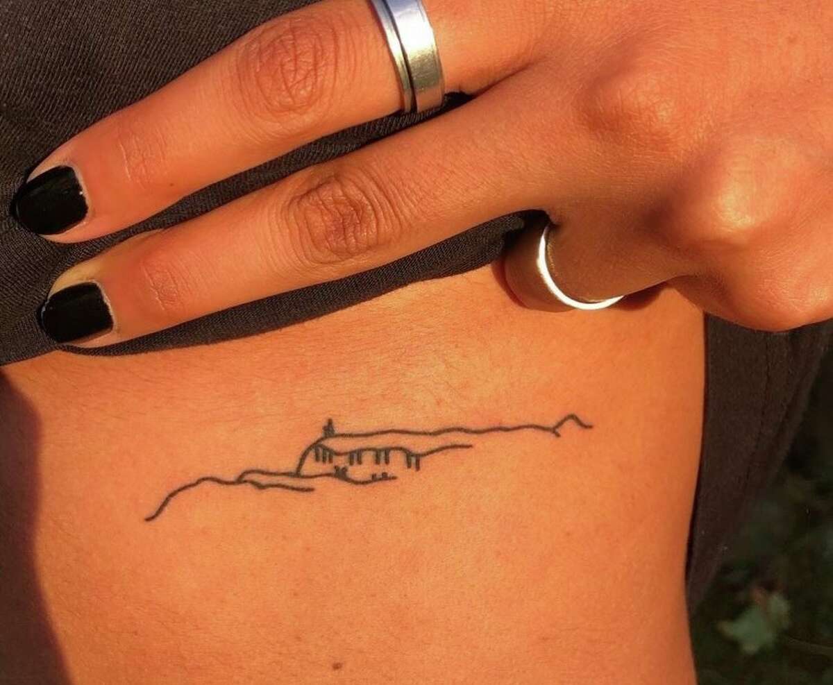 This simple line drawing representing Sky Top Tower and the ridgeline of the Gunks was developed by local tattoo parlor Art in Soul after a hiker came in and requested it. Now it adorns the bodies of many SUNY New Paltz students. Here, Sarah Crespo shows off hers, inked on her left rib cage.