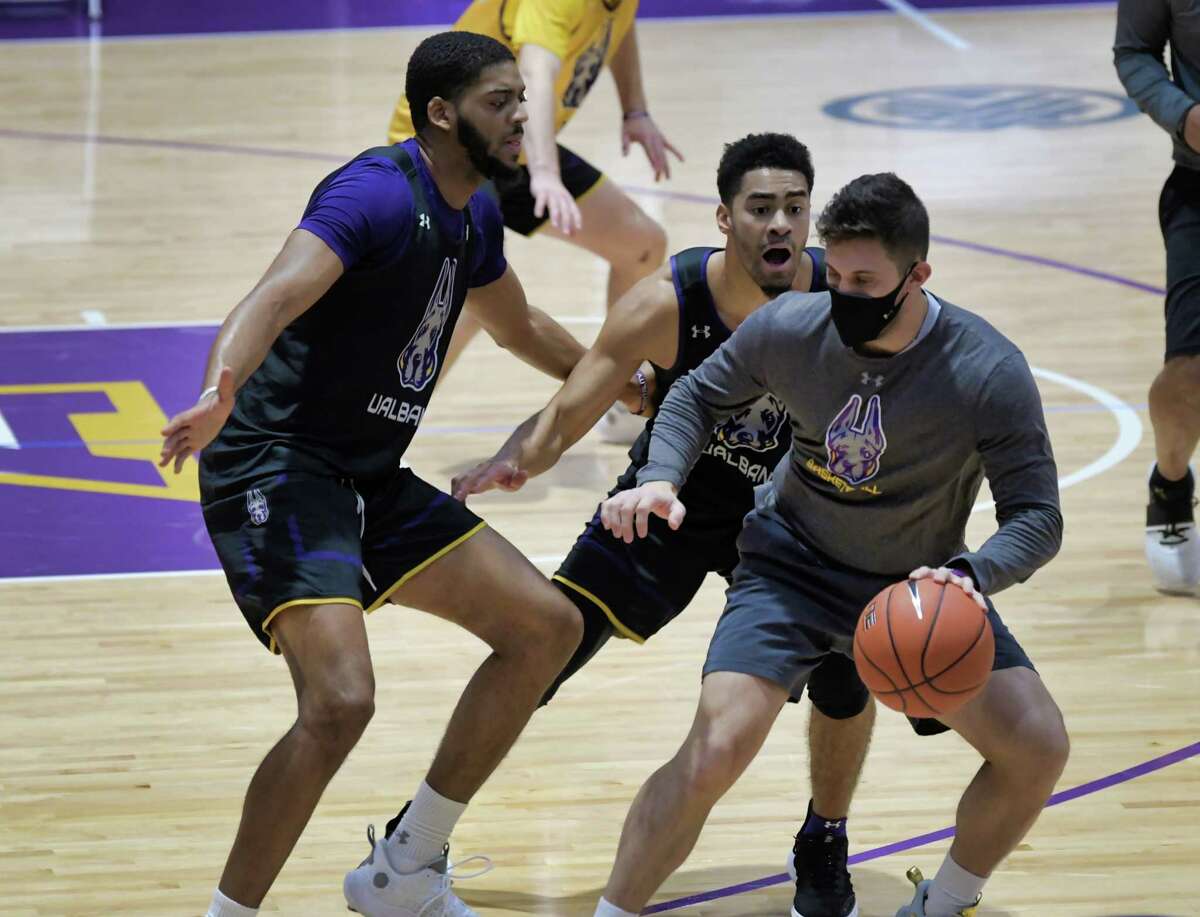 UAlbany men's basketball players, Jarvis Doles, left, and Chuck Champion, second from left, run through drills during practice on Monday, Nov. 29.