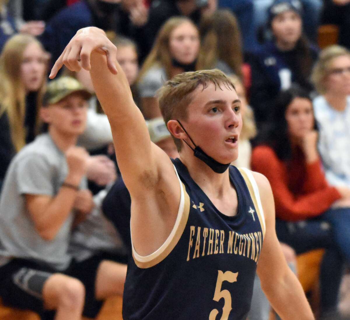 Father McGivney's Jacob Huber eyes a 3-pointer during a game against St. Elmo/Brownstown in Mulberry Grove.