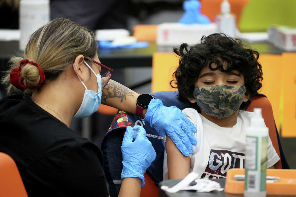 Milan Patel, 7, receives a COVID-19 vaccine. As cases rise in Illinois, health officials said those 17 or younger are being affected the most by new coronavirus infections.