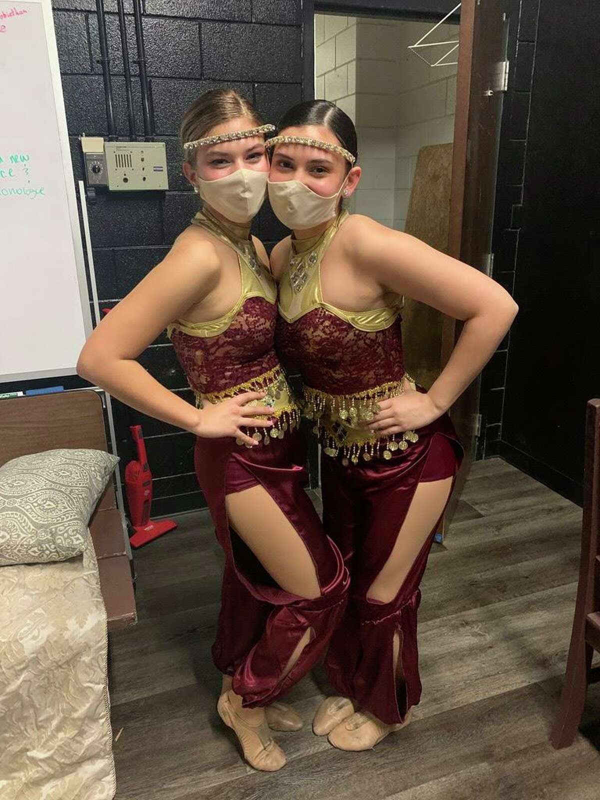Paulina Pearson and Nia Oliva pose for a photograph while filming a virtual version of the school’s winter dance show.