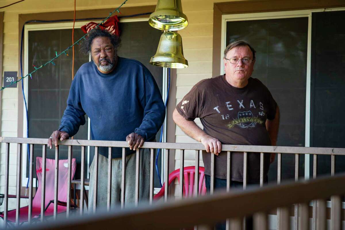 Richard Caudill, left, and Kent Chuchill, right, outside of their apartments, Monday, Nov. 29, 2021, at the Acres Homes Gardens apartments in Houston. A group of tenants living in the 15-unit apartment building have organized with the Houston Tenants Union and have delivered a demand letter to their landlord asking for timely repairs, pest control and an end to alleged threats and harassment made by management. Management has agreed to meet with tenants.