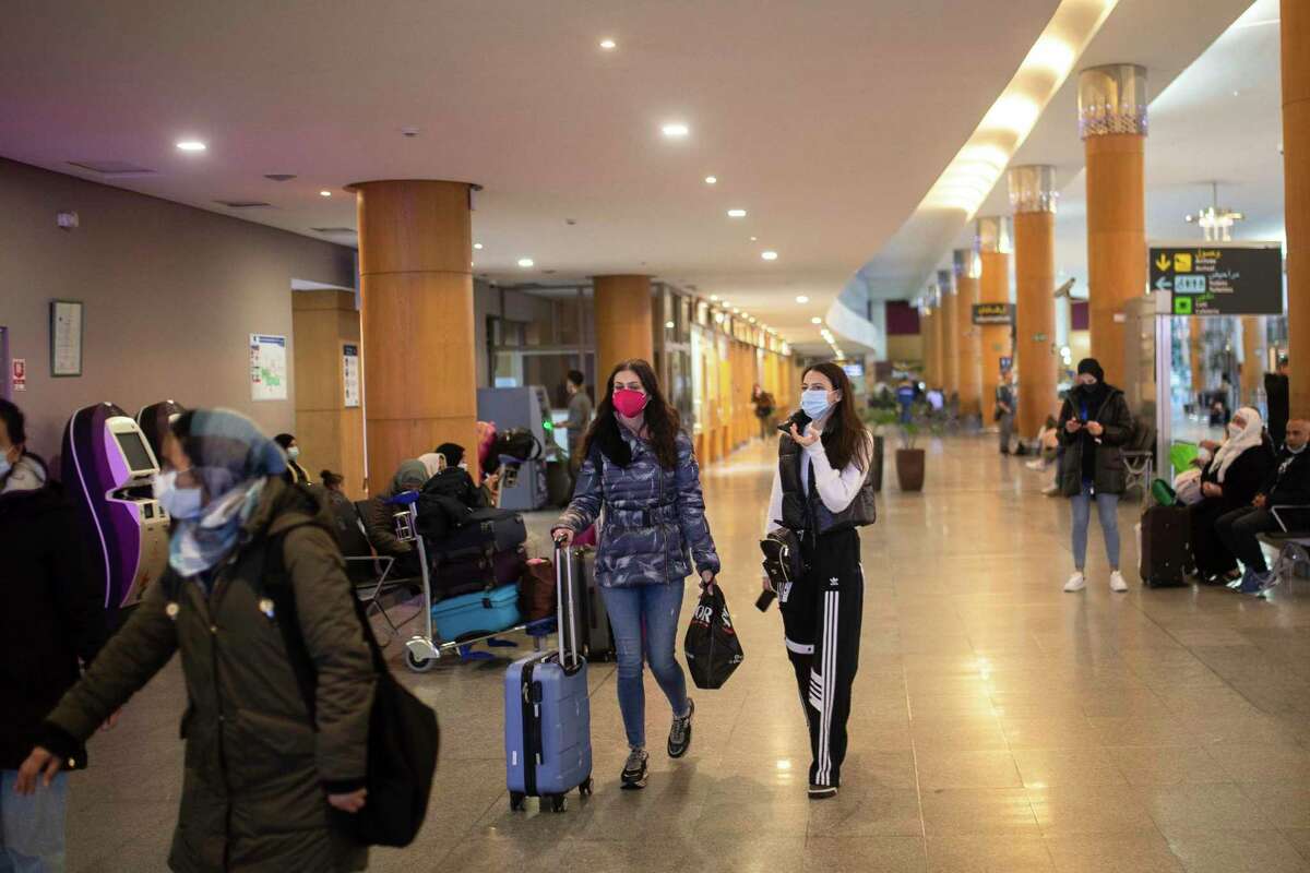 Travelers wear face mask sat Rabat airport in Morocco as concern about the omicron variant of the coronavirus grows.