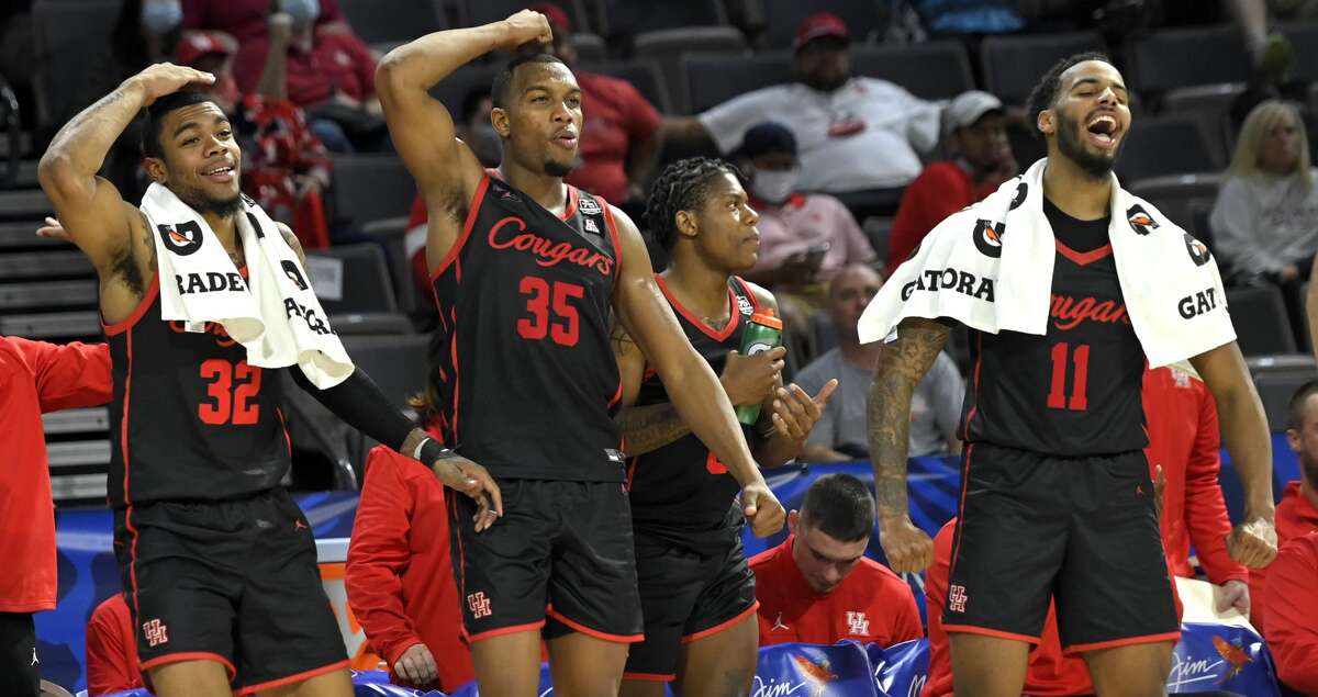 Reggie Chaney #32, Fabian White Jr. #35 and Kyler Edwards #11 of the Houston Cougars react from the bench after a basket against the Oregon Ducks during the 2021 Maui Invitational basketball tournament at Michelob ULTRA Arena on November 24, 2021 in Las Vegas, Nevada. Houston won 78-49. (Photo by David Becker/Getty Images)