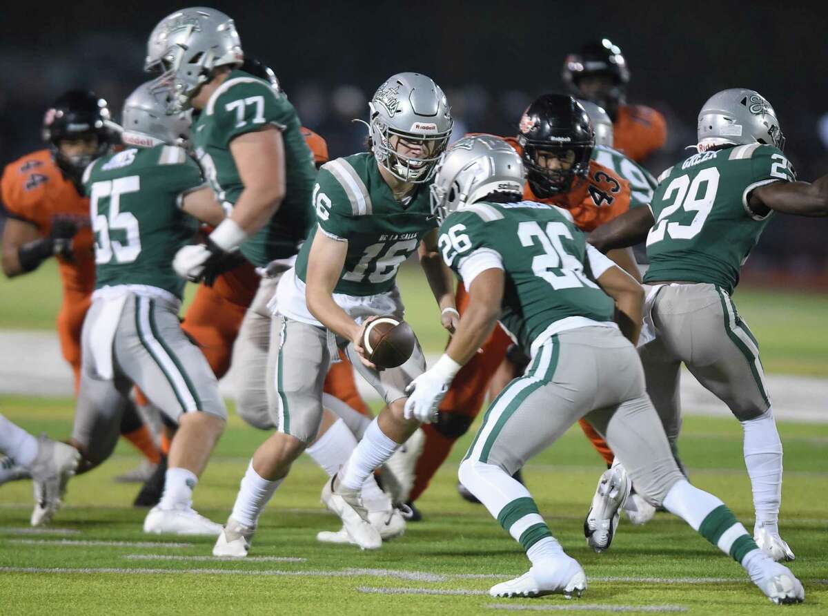 Quarterback Luke Dermon hands off to running back Zeke Barber for De La Salle-Concord, The Chronicle's No. 1 team in this season's penultimate rankings.