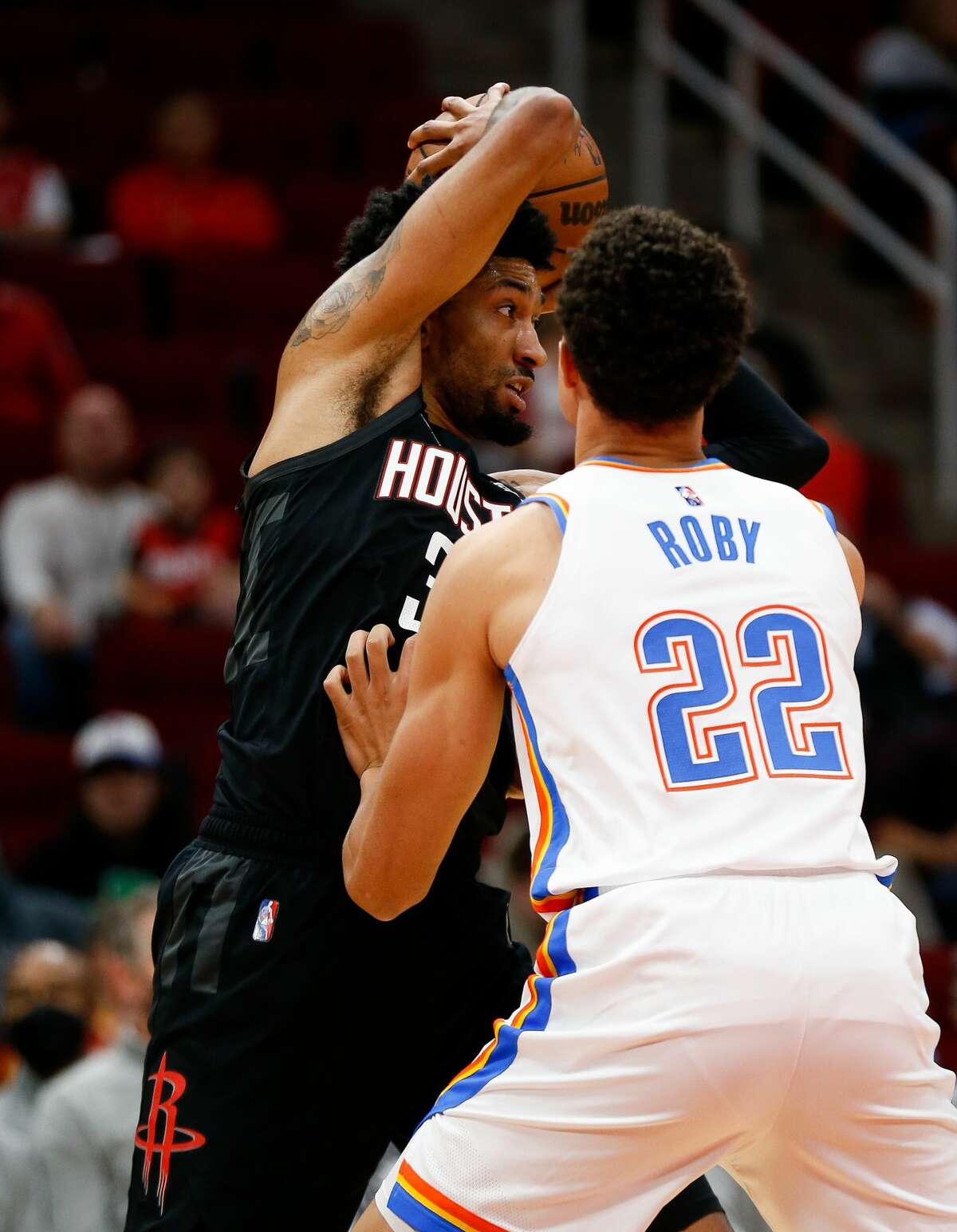 Houston Rockets center Christian Wood (35) shields the ball away from Oklahoma City Thunder forward Isaiah Roby (22) as he looks for an open teammate during the first quarter of an NBA game at Toyota Center on Monday, Nov. 29, 2021, in Houston.