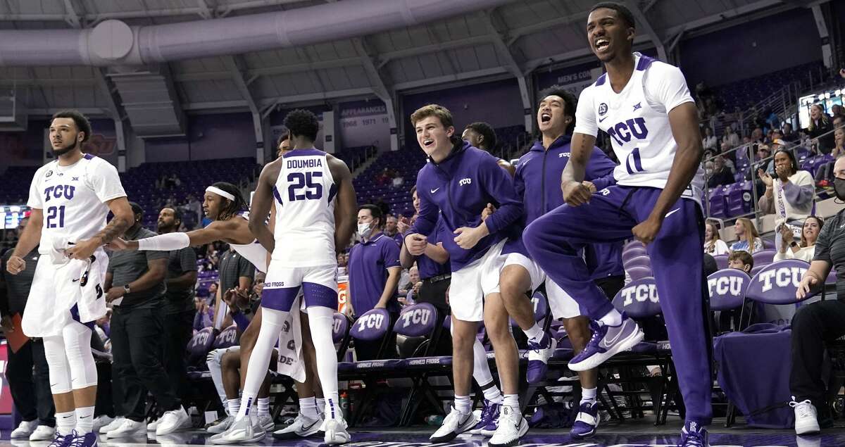 TCU's JaKobe Coles (21), Souleymane Doumbia (25), Darius Ford (11) and the rest of the bench celebrate a score against Nicholls State in the second half of an NCAA college basketball game in Fort Worth, Texas, Thursday, Nov. 18, 2021. (AP Photo/Tony Gutierrez)
