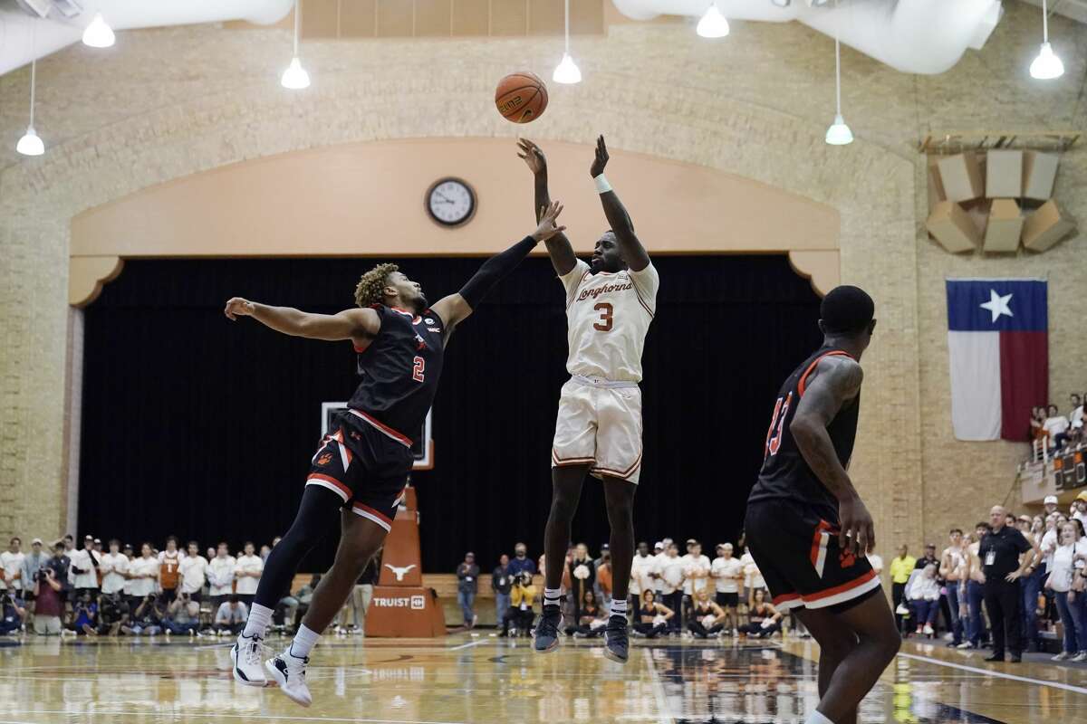 Texas guard Courtney Ramey (3) shoots over Sam Houston State guard Jarren Cook (2) during the second half of an NCAA college basketball game, Monday, Nov. 29, 2021, in Austin, Texas. (AP Photo/Eric Gay)