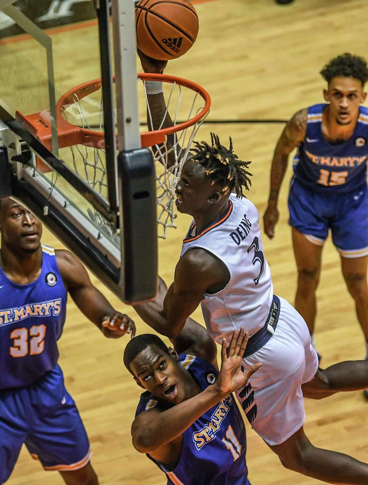 UTSA’S Dhieu Deing (3) drives and scores over Mamady Djikine of St. Mary’s during college basketball action at the UTSA Convocation Center on Monday, Nov. 29, 2021.