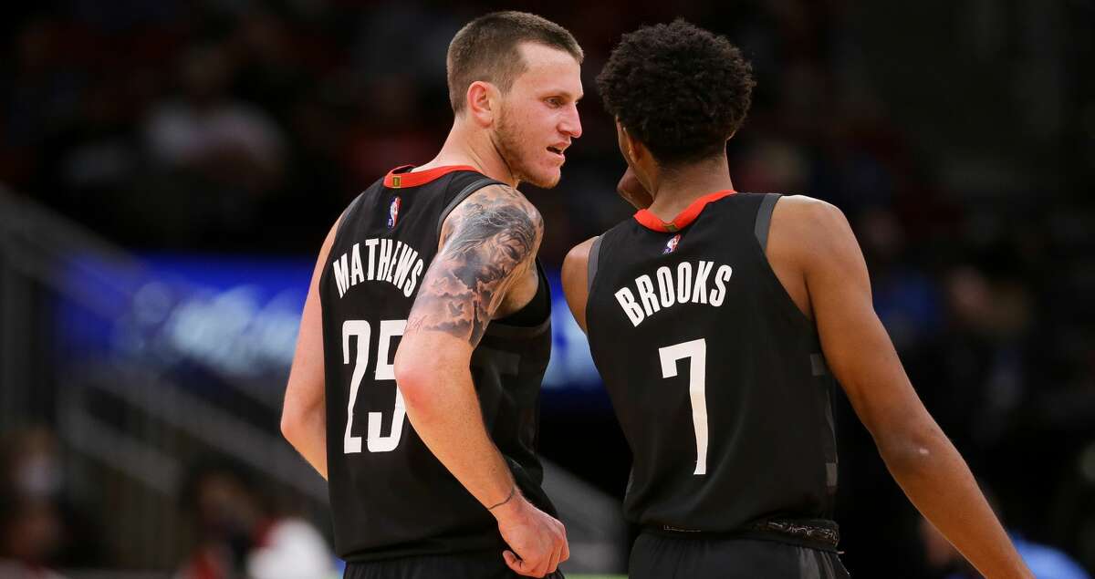 Houston Rockets guard Garrison Mathews (25) talks with guard Armoni Brooks (7) during a timeout in the third quarter of an NBA game against the Oklahoma City Thunder at Toyota Center on Monday, Nov. 29, 2021, in Houston. The Rockets won 102-89.