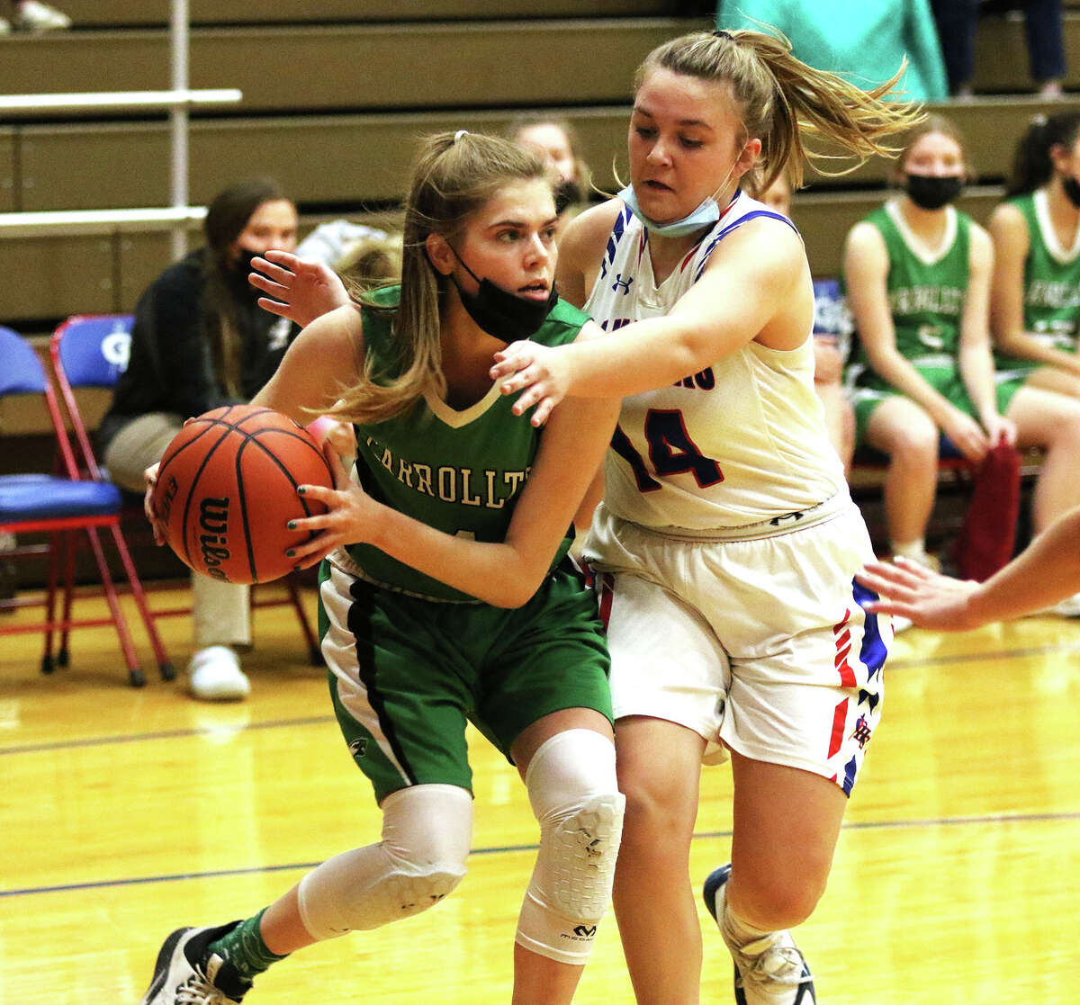 Carrollton's Callie McAdams (right) drives on Carlinville's Braley Wiser in a nonconference girls basketball game Monday night in Carlinville.