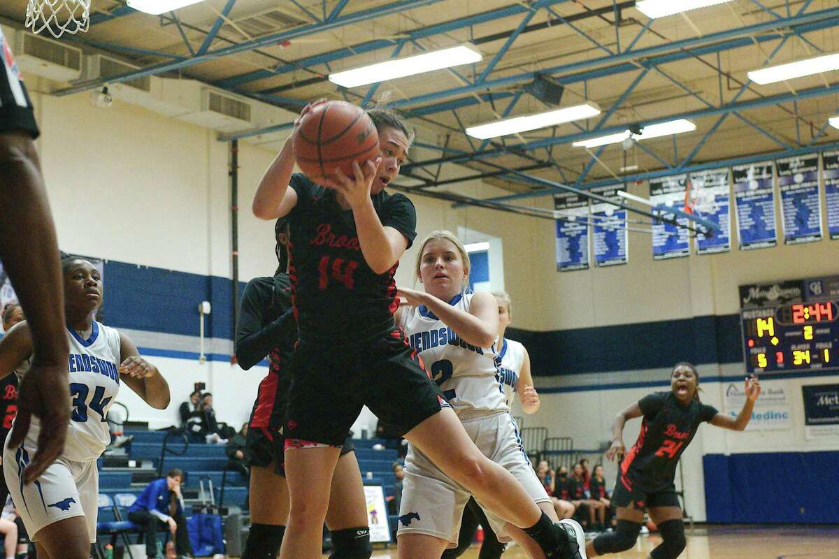 Clear Brook’s Alyssa Berry (14) pulls down a rebound over Friendswood’s Abby Brown (2) at Friendswood High School.