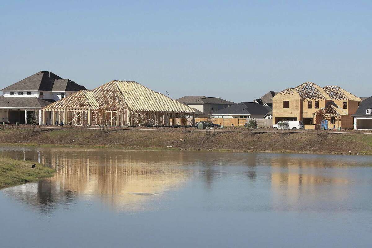 New houses under construction dot the landscape in Manvel’s Del Bello Lakes neighborhood.
