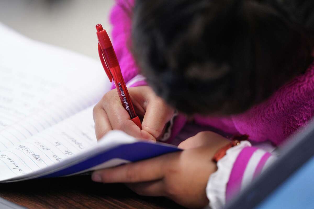 Students at Oak Crest Elementary learn to use a red pen to make edits to a story that the 4th grade journalists hope to get published in "Live from the Southside" magazine.