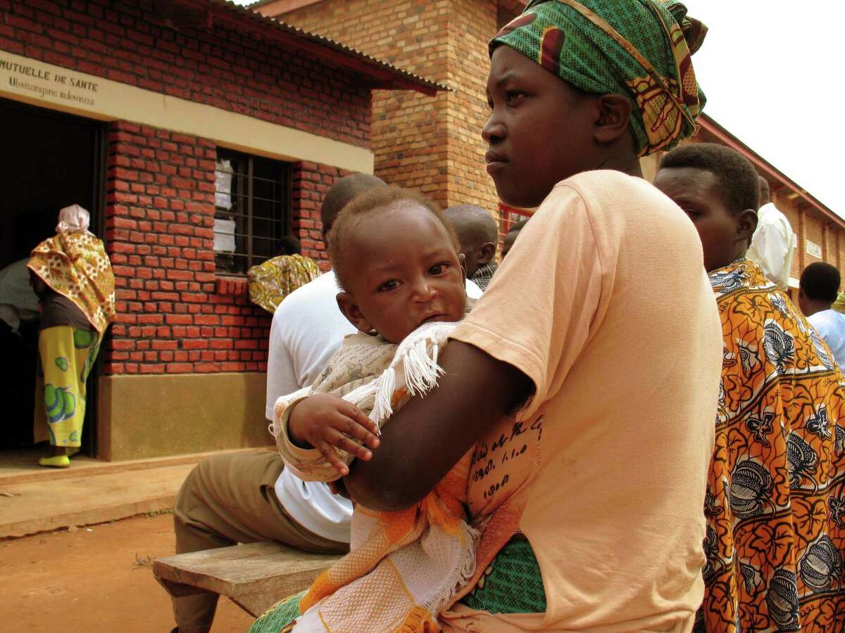 A mother and child wait to receive treatment at an HIV clinic in Rwanda in 2008. The clinic was built with a grant from President George W. Bush's anti-AIDS program known as PEPFAR.