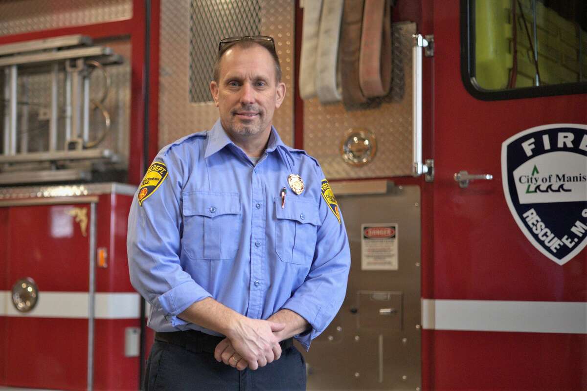 Manistee Fire Chief Mark Cameron stands in front of a fire engine inside the Manistee Fire Department. Cameron was approached by an instructor at Munson Healthcenter to create a clinical agreement that would allow his firefighters to help train the next generation of  paramedics. 