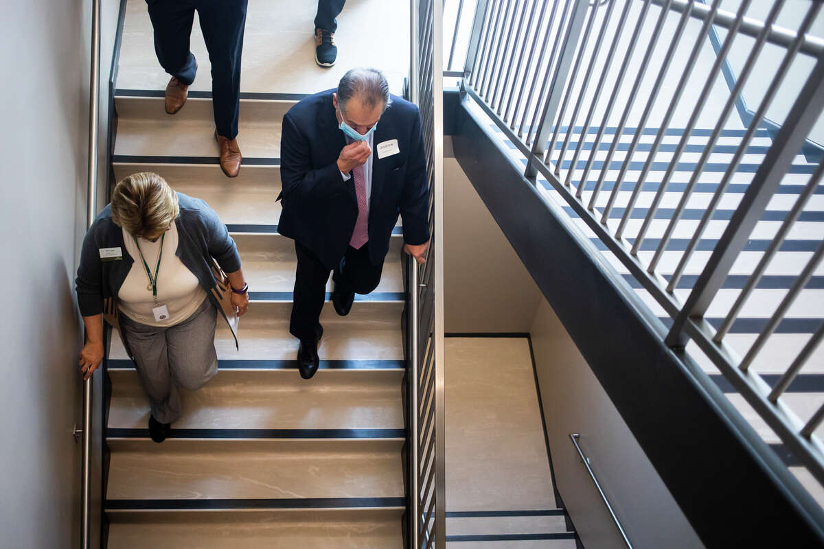 Andrew Liveris, former CEO and chairman of The Dow Chemical Company, right, takes a tour of the Delta College Downtown Midland Center after giving a talk for Delta students and faculty, Dow representatives and community leaders Tuesday, Nov. 30, 2021 in Midland.