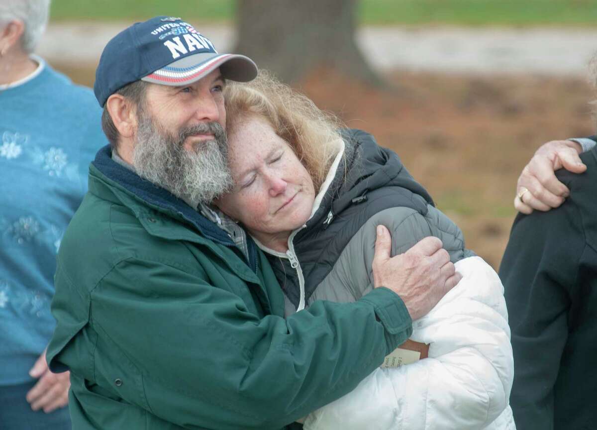 David Connors holds his wife, Laurie, while a sign remembering their daughter who was killed at the hand of a drunk driver was unveiled Tuesday morning. The sign has been placed at the accident site. 
