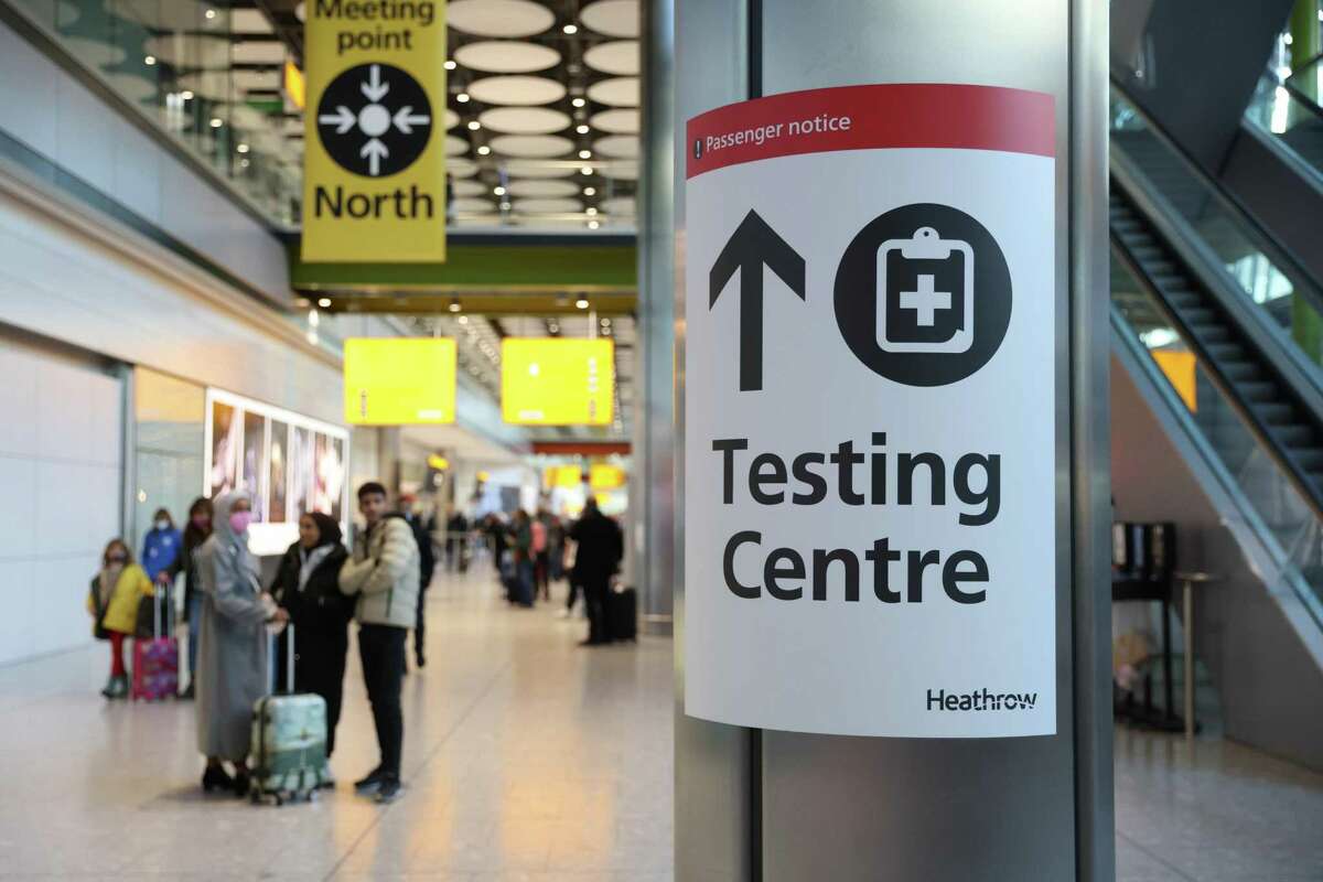 A COVID testing center sign at Heathrow Airport in London is seen on Sunday.