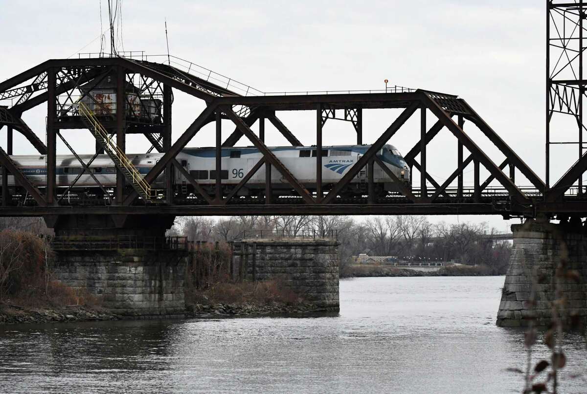 An Amtrak train crosses the Livingston Avenue rail bridge that spans the Hudson River between Albany and Rensselaer is seen on Tuesday afternoon, Nov. 30, 2021, in Albany, N.Y. U.S. Senate Majority Leader Chuck Schumer is urging Amtrak to prioritize repairing the historic 120-year-old bridge after receiving a $22 billion windfall from the $1 trillion infrastructure bill.